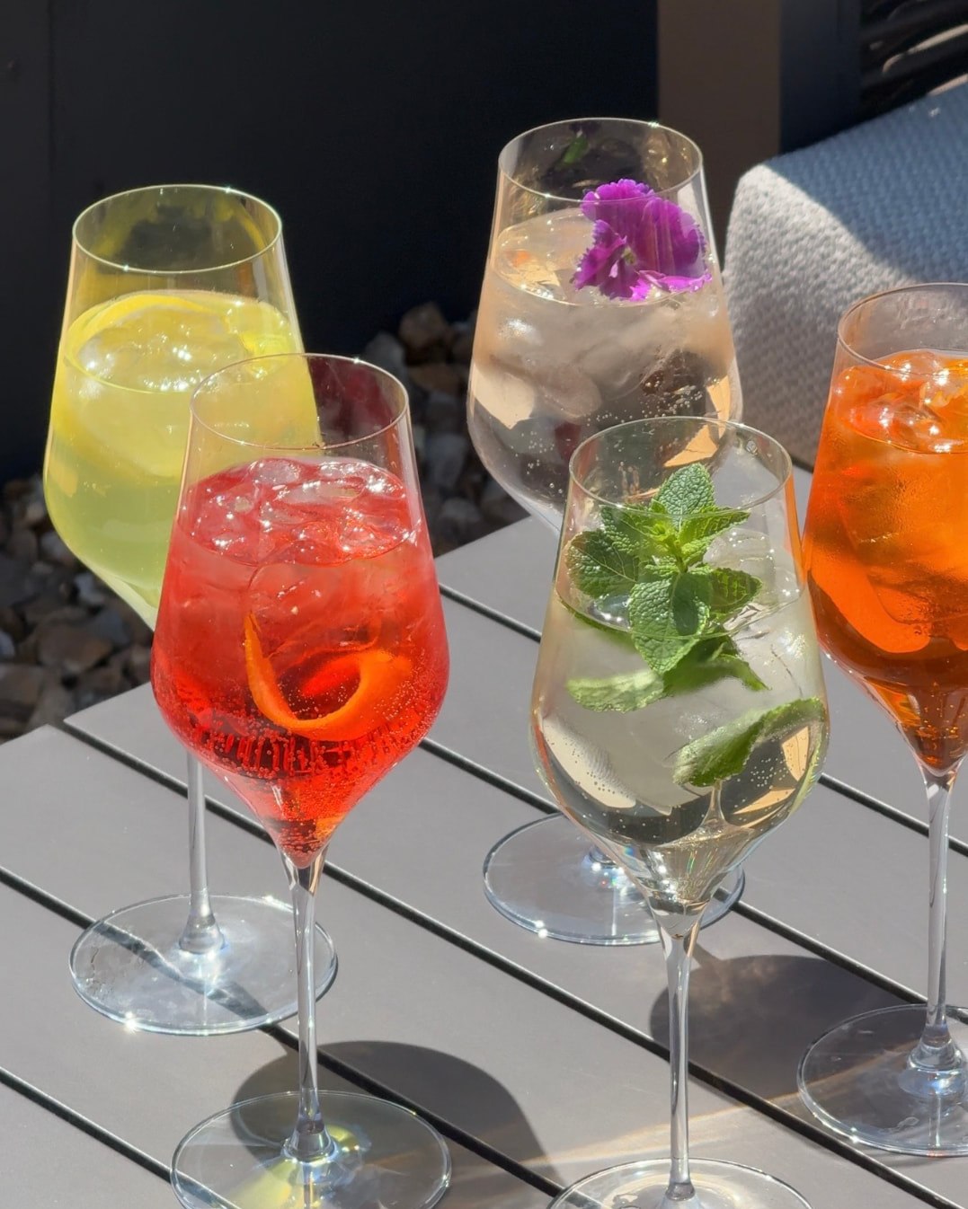 A row of colourful spritzes served on the Courtyard terrace at The Glasshouse, Windlesham